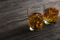 Whisky in two glasses on a dark wooden background Royalty Free Stock Photo