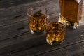 Whisky in two glasses on a dark wooden background Royalty Free Stock Photo