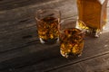 Whisky in two glasses on a dark wooden background. Toning Royalty Free Stock Photo