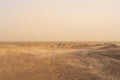 Whisps Of Sand Blow Over The Barren Desert Floor