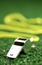 Whistle laying on green astroturf Royalty Free Stock Photo