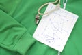 Whistle of a soccer or football referee or coach and a tactical diagram scribble on a track suit Royalty Free Stock Photo