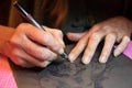 Close up of artists hands while making a custom designed paper cutting art work