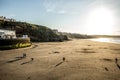 WHITBY in ENGLAND. People walking on Whitby beach on a fine sunny, windy day. In Whitby, North Yorkshire, England. Royalty Free Stock Photo