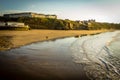 WHITBY in ENGLAND. People walking on Whitby beach on a fine sunny, windy day. In Whitby, North Yorkshire, England Royalty Free Stock Photo