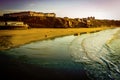 WHITBY in ENGLAND. People walking on Whitby beach on a fine sunny, windy day. In Whitby, North Yorkshire, England Royalty Free Stock Photo