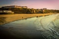 WHITBY in ENGLAND. People walking on Whitby beach on a fine sunny, windy day. In Whitby, North Yorkshire, England Royalty Free Stock Photo