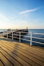 WHITBY, ENGLAND  Tourists visiting Whitby Pier and lighthouse in May Royalty Free Stock Photo