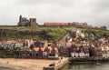 View of Whitby Abbey ruin and old houses in coastal seaside town, Yorkshire