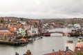 View of Whitby including the river, bridge and old houses in coastal seaside town, Yorkshire