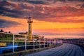 Whitby pier at the harbor entrance at sunset in Whitby, North Yorkshire, UK Royalty Free Stock Photo