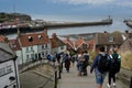 Tourists on their way in Whitby down to pier and lighthouse