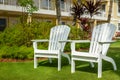 White Adirondack Chairs in a Garden