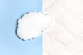 White air cloud on a comfortable mattress texture background and blue background top view. White texture of mattress bedding Royalty Free Stock Photo