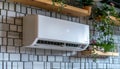 White air conditioner hangs on brick wall of urban building Royalty Free Stock Photo