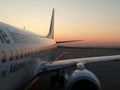 White airplane on a background sunrise