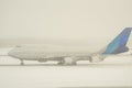 White airplane taking off in heavy snoy with snoing backgroundcolor edited