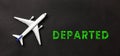 White airplane and text departed on a black background