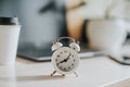 White alarm clock on the desktop in the office Royalty Free Stock Photo