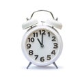 White alarm clock at 11 eleven o`clock isolated on white background clipping path