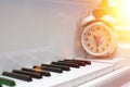 White alarm clock on piano keys Royalty Free Stock Photo