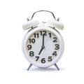 White alarm clock at 7 seven o\'clock isolated on white background (clipping path) Royalty Free Stock Photo