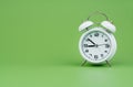 alarm clock tells time working with time importance of time punctuality White clock on a green background