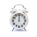 White alarm clock at 12.00 twelve o`clock, noon isolated on white background clipping path Royalty Free Stock Photo