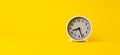 alarm clock on yellow background with space for text, time ideas and work