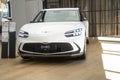 white all-electric Hyundai Genesis GV60 in Studio, popular korean Electric SUV vehicle in showroom, alternative energy development