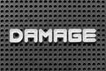 White letter in word damage on black pegboard background Royalty Free Stock Photo