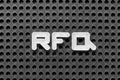 White letter in word RFQ abbreviation of request for quotation on black pegboard background