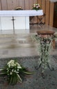 White altar of the Christian church with the baptismal font duri