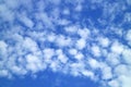White Altocumulus Clouds Scattered on Vibrant Blue Sky Royalty Free Stock Photo