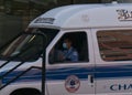 White ambulance parked with its passenger doors shut