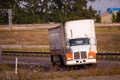 Big rig semi truck auto train with two trailers turning on the h Royalty Free Stock Photo