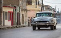 White american vintage car drives in the province Villa Clara in Cuba on the street