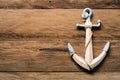 The white anchor is placed on a wooden floor. Royalty Free Stock Photo