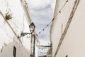 White andalusian village street with colorful lightbulbs