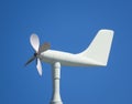 White anemometer wind vane on blue sky background Royalty Free Stock Photo