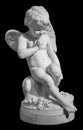 White angel figurine isolated on black background. Cupid sculpture. Stone statue of young cherub Royalty Free Stock Photo