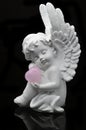 White Angel holding Rose Quartz heart Royalty Free Stock Photo