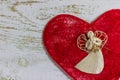 White angel on a red heart. Postcard Happy Valentine`s Day. Light wooden background, place for text, Valentine card. Royalty Free Stock Photo