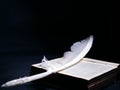 White angelic feather rests on the Bible holy book