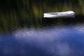 White angelic single lonely boat floating peaceful bliss mindfulness in calm water with blue sky reflection sun shinning brightly