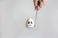 Angry egg in spoon Royalty Free Stock Photo