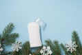 White antiperspirant or deodorant with christmas tree and snowflakes on blue background, copy space Royalty Free Stock Photo