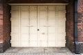 White antique iron door with lock on red brick wall background Royalty Free Stock Photo