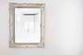 White antique vintage mirror wooden frame on white wall