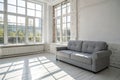 White apartment with gray sofa and sunlight Royalty Free Stock Photo
